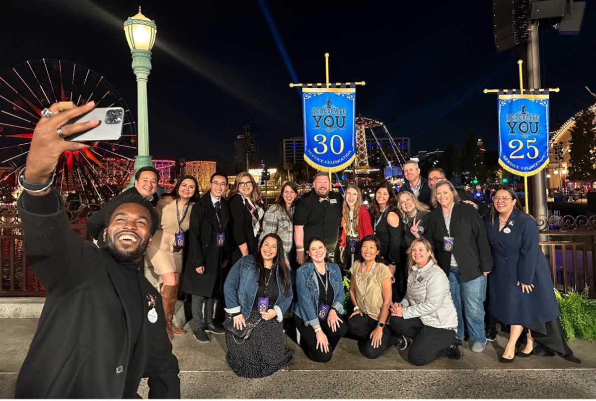 group of cast members takes a selfie